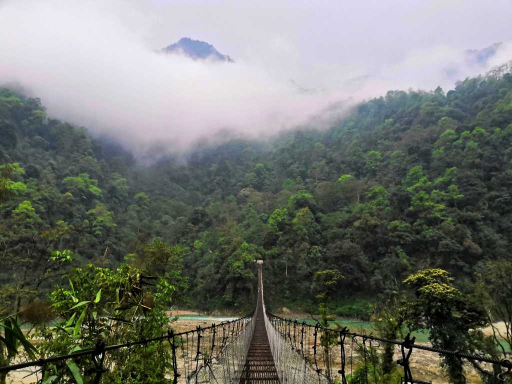 Long Suspension Bridge and cloud-covered mountains in Dzongu in North Sikkim