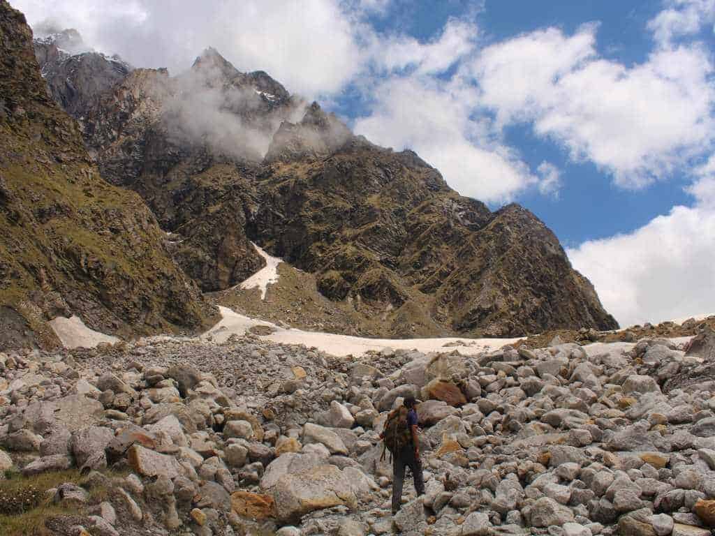 Trekker walking on boulders_Dev Kyara Trek in Uttarakhand