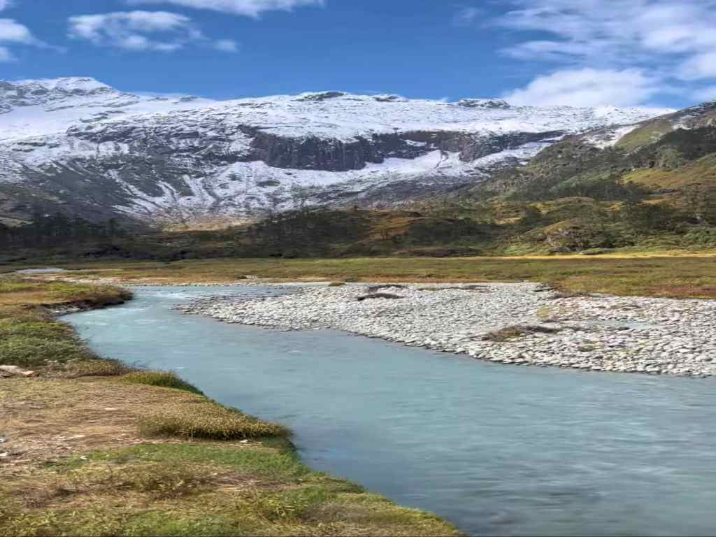 River valley with backdrop of snow-capped mountains on Dibang Valley Tour__Eka Experiences™